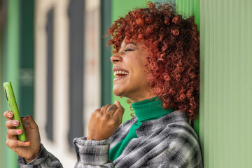 girl looking at mobile phone or smartphone with expression of success