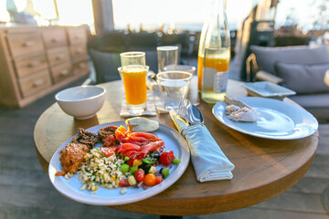 Delicious appetizing seafood breakfast with orange juice on the open veranda of the restaurant