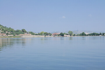 Fototapeta premium The City Palace by lake Pichola in Udaipur, the city of lakes in the Province of Rajasthan, India.