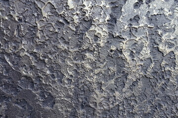 Closeup of glossy gray and gold wall with decorative stucco finish