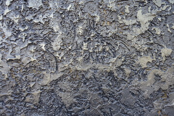 Surface of glossy gray and gold wall with decorative stucco finish