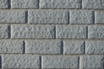 Closeup of Light grey painted brick veneer wall