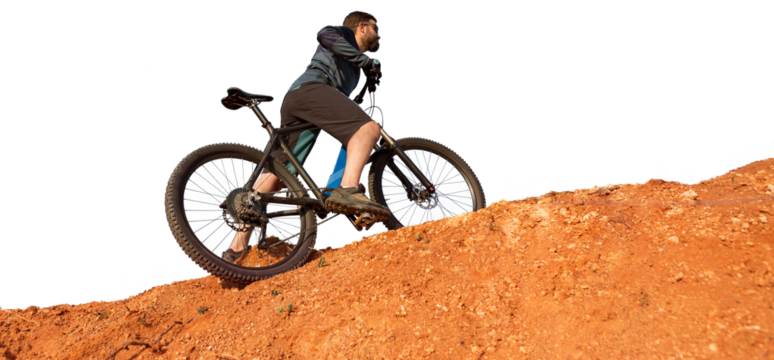 Cyclist in pants and fleece jacket on a modern carbon hardtail bike with an air suspension fork. The guy on the top of the hill rides a bike.