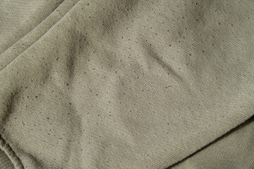 Lints on green sweater. Before cleaning and collected fluff lint. Closeup Pilled Clothes. Old used...