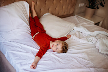 cute little naughty baby lying on parents bed, doesn't want to sleep. baby daytime sleep, how to...