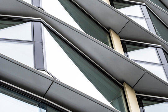 Abstract detail of a metal and glass facade in London, showcasing dynamic patterns and structural complexity.