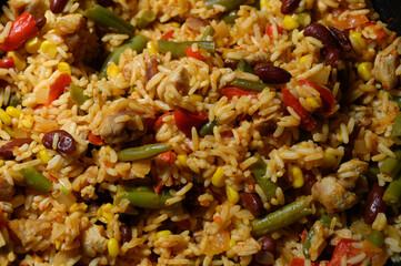 Savory rice dish with colorful vegetables and tender chicken served in a warm kitchen
