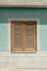 Elegant shutters on a textured mint and white wall. Rustic charm