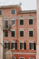 Pink Residential Building with Green Windows