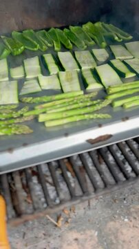 Vegetarian and vegan outdoor barbecue. Grilled peppers, zucchini and asparagus. Vertical video. No sound.
