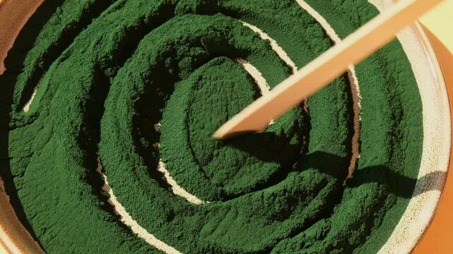 Organic blue-green algae spirulina powder food in plate. Health benefits of spirulina chlorella. Vitamins and minerals to diet. Detox dietary supplement Seaweed superfood concept