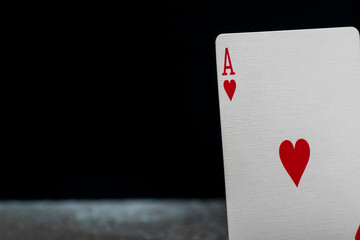 Close-up of the Ace of Hearts on a dark background. The iconic red heart and bold letter 'A' stand out, symbolizing luck, passion, and high-stakes card games.