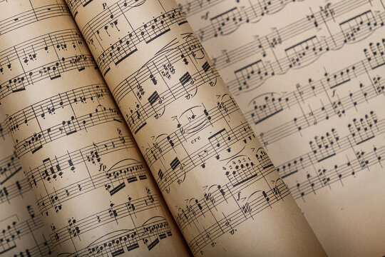 Close up of vintage sheet music with retro melody, nostalgic, artistic background music themes, for concert posters, evening banners, music blogs on social networks