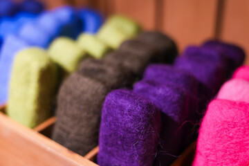 Natural wool felted soap. Colourful background. 