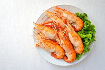 Boiled prawn in white ceramic plate on white background , top view food table with free copy space	
