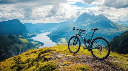 Fototapeta premium A modern gravel bike parked on a mountain ridge, overlooking a scenic valley.