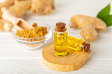 Ginger essential oil on texture background. Fresh ginger slices. Essence, serum, oil. Alternative medicine. Phytotherapy. Health and beauty concept. Place for text. Copy space.