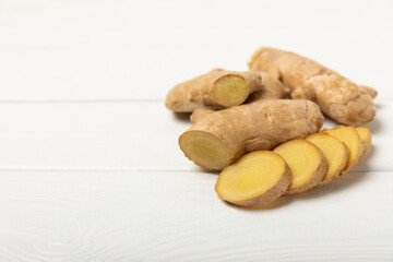 Fresh ginger on wooden background. Dry ginger. Sliced ​​ginger with honey and lemon. Ginger root. Traditional alternative medicine, healing tea for immunity. Seasoning and spices concept. Copy space.