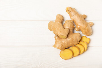 Fresh ginger on wooden background. Dry ginger. Sliced ​​ginger with honey and lemon. Ginger root. Traditional alternative medicine, healing tea for immunity. Seasoning and spices concept. Copy space.