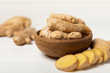 Fresh ginger on wooden background. Dry ginger. Sliced ​​ginger with honey and lemon. Ginger root. Traditional alternative medicine, healing tea for immunity. Seasoning and spices concept. Copy space.