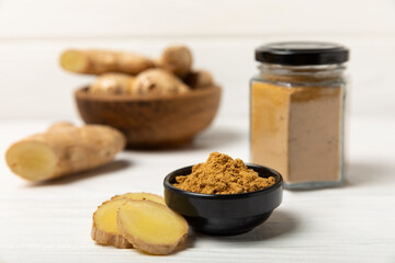 Fresh ginger on wooden background. Dry ginger. Sliced ​​ginger with honey and lemon. Ginger...
