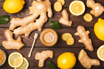 Fresh ginger on wooden background. Dry ginger. Sliced ​​ginger with honey and lemon. Ginger...
