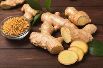 Fresh ginger on wooden background. Dry ginger. Sliced ​​ginger with honey and lemon. Ginger...