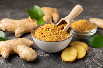 Fresh ginger on wooden background. Dry ginger. Sliced ​​ginger with honey and lemon. Ginger root. Traditional alternative medicine, healing tea for immunity. Seasoning and spices concept. Copy space.