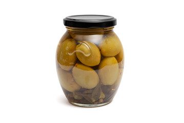 green olives in a glass jar on a white background