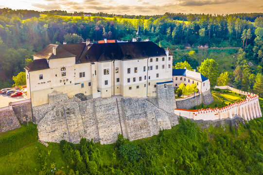 A stunning view of the massive stone walls of Cesky Sternberk Castle in Czech Republic, showcasing its medieval fortress design, and towering structure, with a picturesque landscape