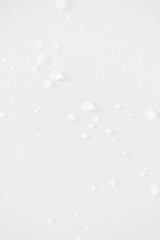 Water drops minimal white background vertical. Moisturizing and hydrating skincare beauty product concept