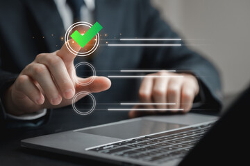 Hand Touching Checkbox with Green Tick Sign on Laptop Screen