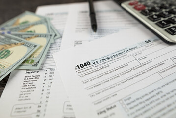 Fototapeta premium Tax form 1040 on dark wooden background, financial document.
