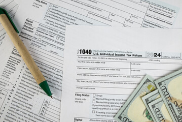 Tax form 1040 on dark wooden background, financial document.