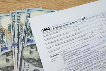 Obraz premium Tax form 1040 on wooden office desk, financial document.
