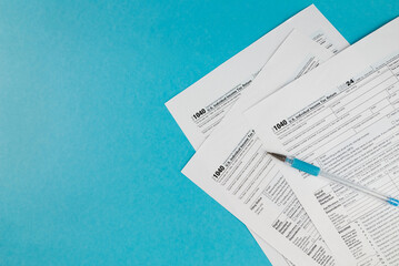 Tax form 1040 on a beautiful blue background, financial document.
