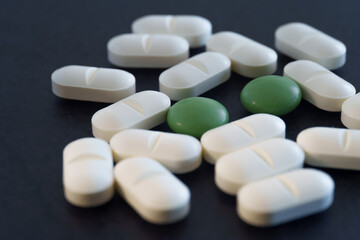 Close-up Medical Pills and Capsules on Dark Surface