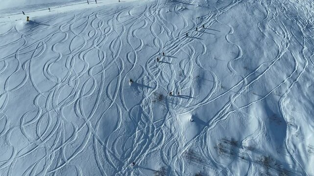 Aerial drone view of freeride ski and snowboard in winter. Riding in powder on ski and snowborad. Ski, Snowboard freeride i deep powder snow. Sunny winter in dolomites, alps.
