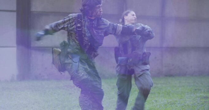 Steady cam shot of male and female soldiers in hand to hand combat 