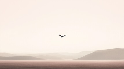 Naklejka premium A soaring bird travels above serene mountains and flatlands
