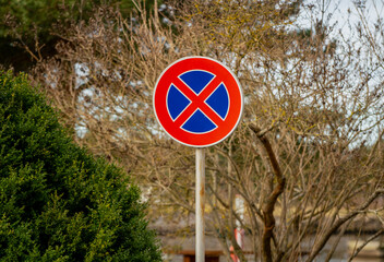 Road sign for car drivers that forbids to stand or stope the car on the side of the road. Blue and...