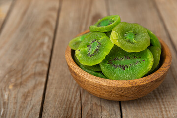 Kiwi dried fruit on wooden background. kiwi candied fruit. Healthy food. Ingredient for baking...