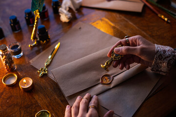 sealing wax. The girl seals the envelope with a wax seal.