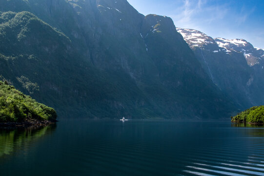 A motorboat sailing down a fjord in Norway