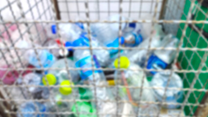 blur background used plastic bottles in trash. recycle. save the world