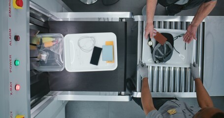 Diverse People, Travelers Putting Personal Items in Plastic Trays for X-ray Scanning on Conveyor...