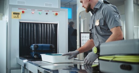Airport Security Checkpoint: Security Officer Putting Suitcases and Personal Items in Trays on...