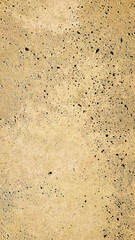 Dark yellow old stone background with dark relief recess coating. Decorative background imitation stone coating