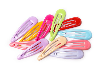 Many colorful hair clips isolated on white, top view