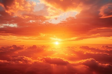 Fototapeta premium Serene Sunset: Birds Flying Under Warm Orange Sky with Sunlight Streaming Through Clouds